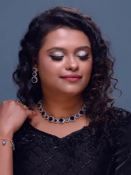 An elegant closed-eye shot to show the detail of the glittery eye makeup and the sharp winged liner.