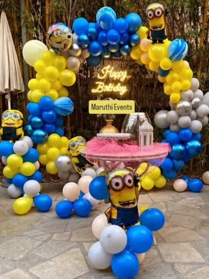 Creating a fun and playful Minions party in an outdoor setting. This circular balloon arch in signature yellow and blue, complete with Minion characters and a neon sign, shows how I can transform any space, indoors or out.
