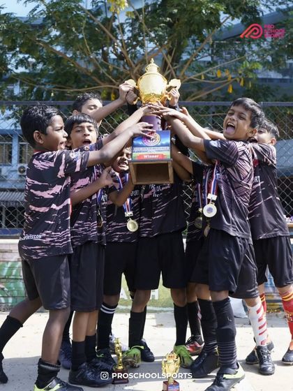Lifting the trophy high! The culmination of teamwork, effort, and passion for the game.