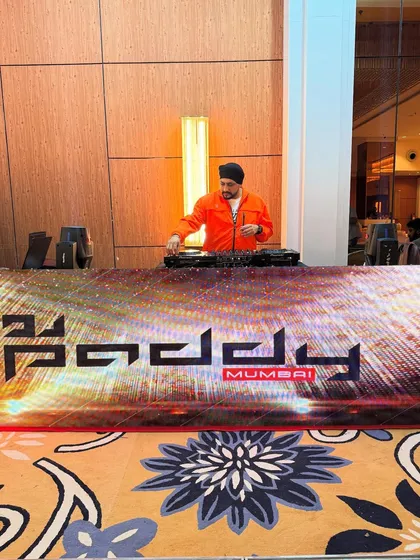 My branded DJ booth and console ready for a Thursday night reception. The LED setup adds a modern, high-tech feel to any event.