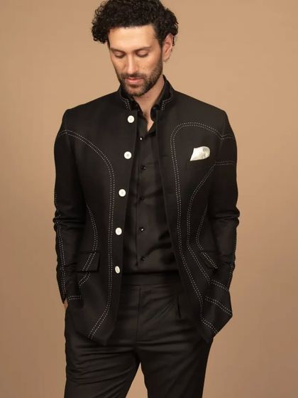 Get into elegance with my designer black Bandhgala, featuring intricate abstract contrast thread stitching. This adds a touch of artistry and sophistication to your ensemble.