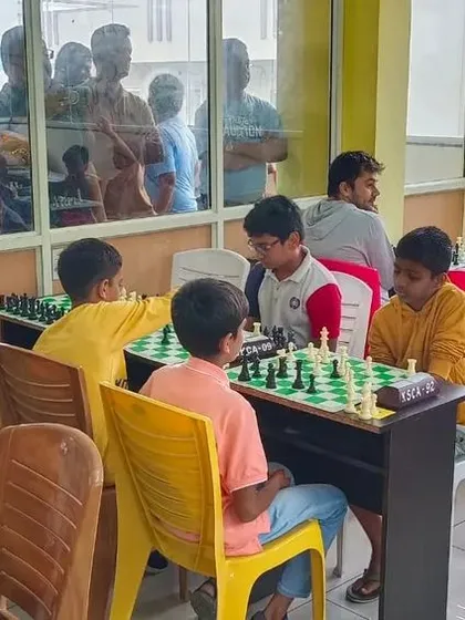 A view from outside the playing hall shows parents and spectators watching the intense matches unfold at our tournament at The Sunshine Library.