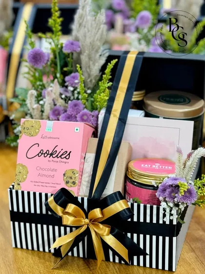 This black and gold striped box, overflowing with fresh flowers and gourmet treats, is a luxurious and celebratory gift. It’s perfect for birthdays, anniversaries, or as a high-end corporate thank you.