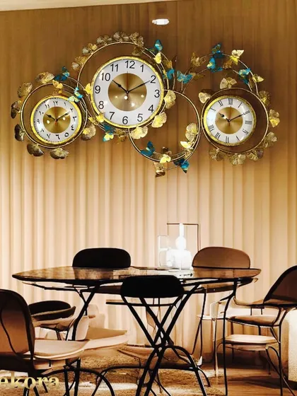 A truly unique piece for a large wall, this decorative clock features three individual dials, perfect for tracking multiple time zones in a global home or office.