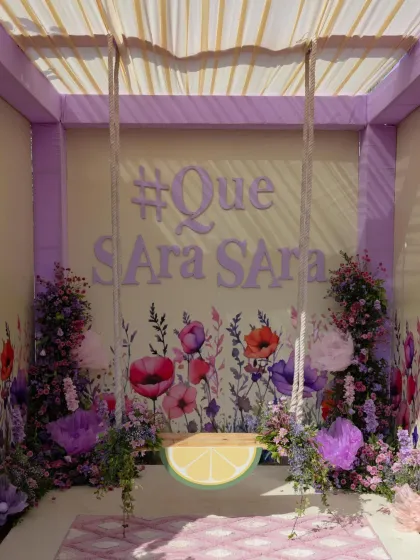 A custom photo booth with a floral swing and the couple's wedding hashtag. I design these interactive spots to be both beautiful and fun, encouraging guests to capture and share memories.