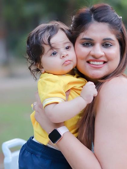 A happy mother holding her adorable son, both smiling brightly. These portraits are filled with the warmth and joy of their bond.