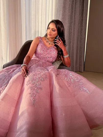 A full-length shot of the bride in her magnificent, princess-style reception gown.