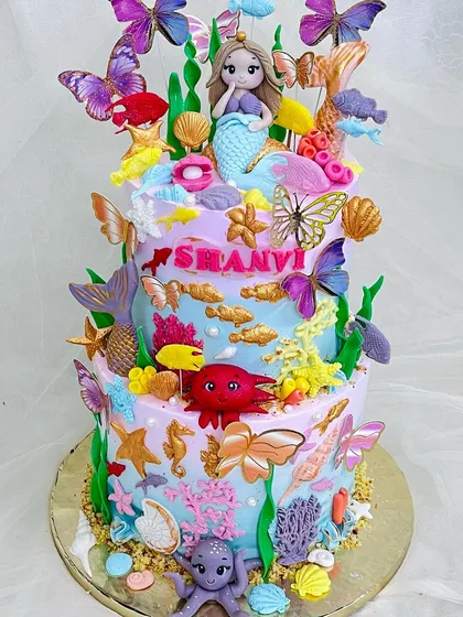 Full view of the stunning two-tier mermaid and butterfly cake.