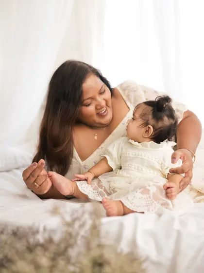 A mother playing with her baby's feet. These playful, simple interactions make for the most heartwarming photographs.