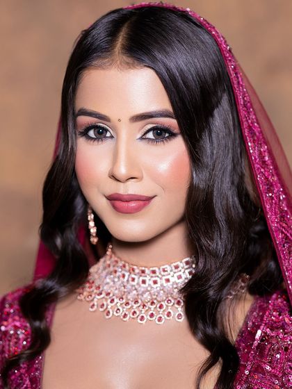 A close-up on a soft glam makeup look, perfectly accented by a delicate diamond and ruby choker set. This beautiful jewellery is available for rent to complete your party look.