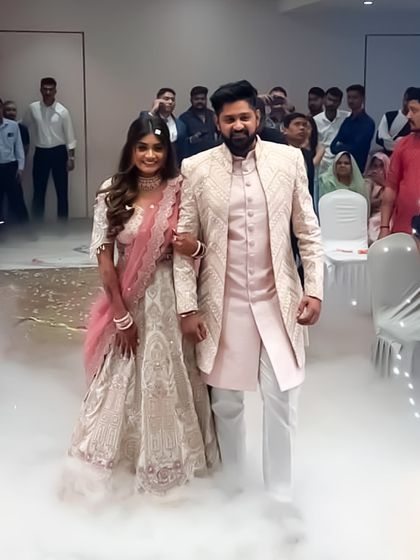 Some love stories are styled best on rent. This couple looks picture-perfect in their coordinated wedding reception outfits.