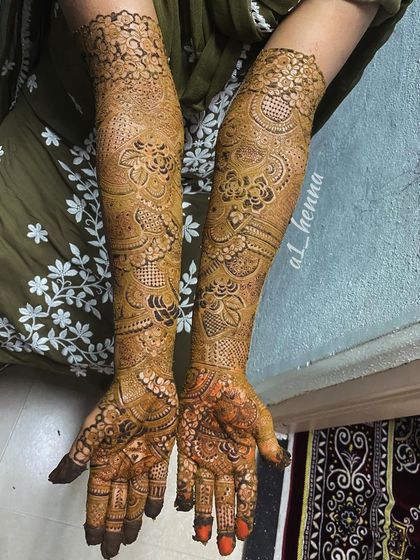 The full view of bride Daniya's henna, extending up to her elbows with personalized details hidden within the pattern.