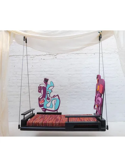 The swing shown with one backrest on either side, creating a balanced yet artistic look. The fabric for the cushion is from Paiwand studio, crafted from colorful waste materials.