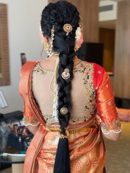 A slightly different angle of the textured braid with gold accessories, showing the dimension and detail of the hairstyle.