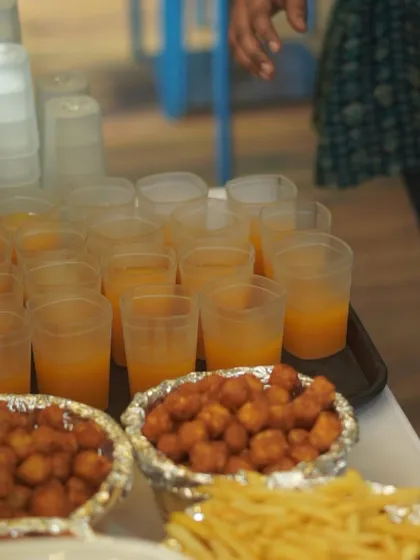 I provide a full spread of party snacks that kids love. This catering setup includes chicken nuggets, french fries, and juice, ensuring no one goes hungry during the celebration.