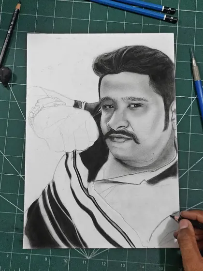 The beginning of a commission portrait. I start with a light sketch to get the placement and proportions right before committing to darker shading. This one is laid out on a cutting mat which helps with alignment.