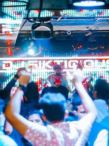 A view from the crowd, looking up at my illuminated name. The branding is strong, the energy is stronger.