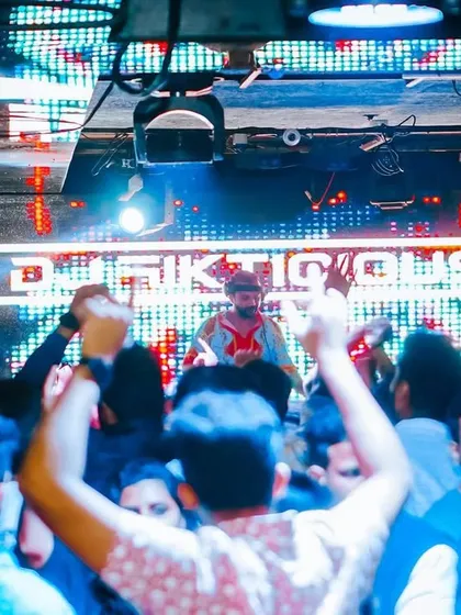 A view from the crowd, looking up at my illuminated name. The branding is strong, the energy is stronger.