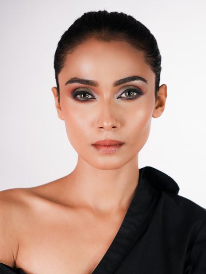 A straight-on look that allows for a clear view of the symmetrical and well-blended eye makeup, a testament to technical skill.