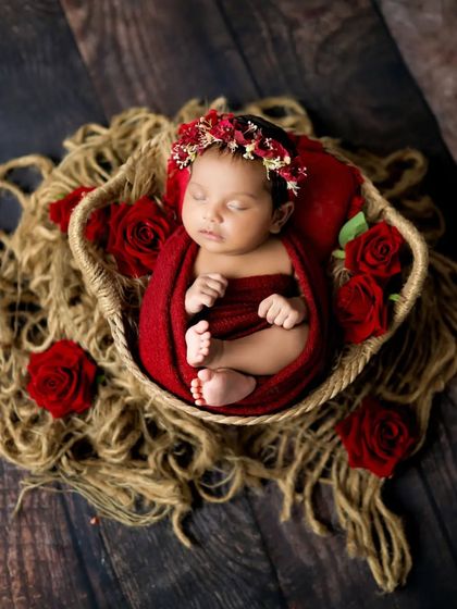 A closer look at this beautiful baby in red. The floral crown and rustic basket add so much charm to this newborn portrait.