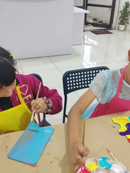 A closer look at the kids painting their desk calendar stands, a fun activity for a New Year themed birthday party.