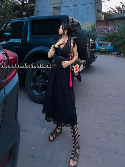 Be a baddie in black. This black maxi dress with lace details is given an edgy twist with gladiator sandals and a colorful, quirky bag. It's a perfect mix of feminine and tough.