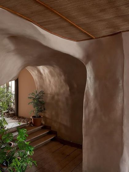 An archway within the cave-like structure of Dubki, framing a glimpse of the greenery and steps beyond. I used muted, earthy tones and natural materials to create a warm and immersive entrance experience.