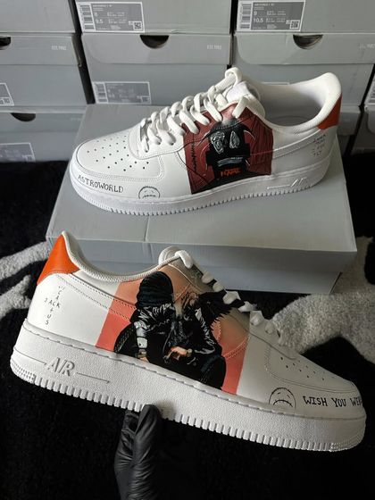 Another angle of the Travis Scott custom sneakers, showing the different artwork on each shoe.