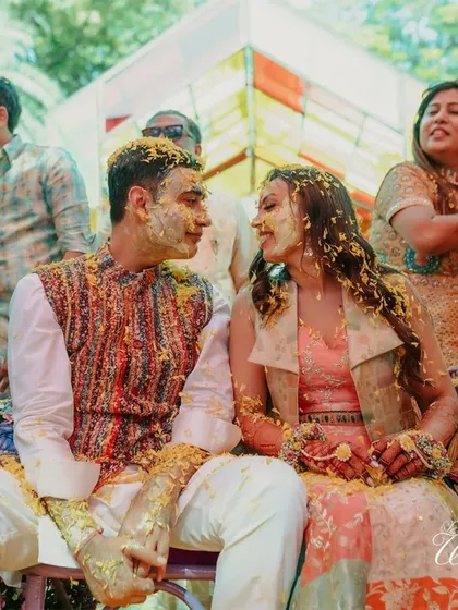 A beautiful moment of connection between the couple amidst the Haldi celebrations. Even covered in turmeric, their love for each other shines brightly.