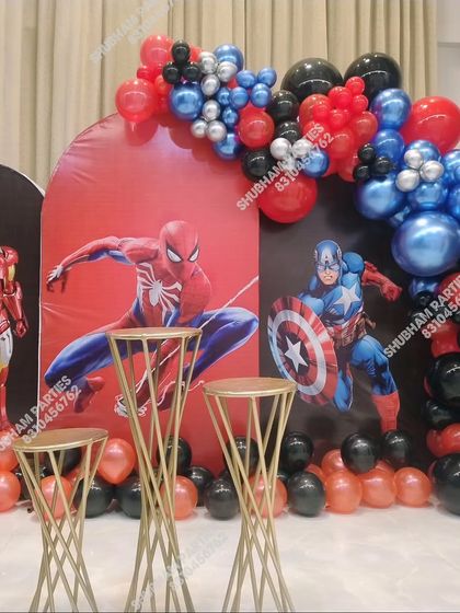 An action-packed Avengers theme party featuring character backdrops of Iron Man, Spider-Man, and Captain America.
