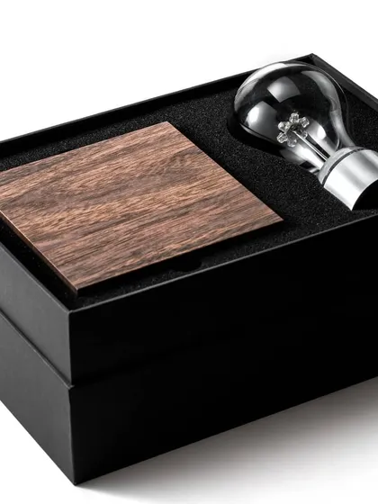Each FLYTE product arrives in premium, elegant packaging, making it an unforgettable gift. This image shows the unboxing experience for the Manhattan light bulb, revealing the walnut base and shatterproof bulb nestled securely inside.