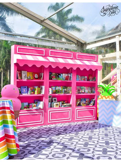 As a unique party favour idea, I created this bright pink book stall. It was designed to look like a sweet shop, allowing each child to pick a book to take home.