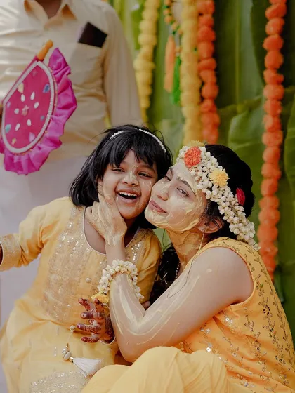 Another angle of the bride sharing a sweet moment with a little one. Capturing these interactions adds a layer of warmth and family connection to the wedding album.