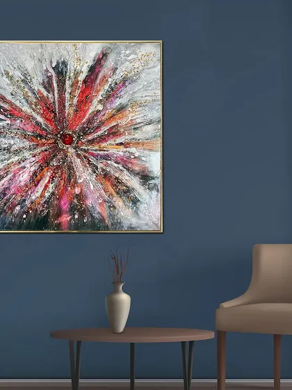 An explosive burst of color and texture, this resin art piece uses reds, whites, and blacks to create a dynamic, starburst-like effect. The central red gem adds a focal point to the abstract design.