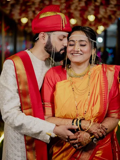 The groom whispers something sweet to his smiling bride.
