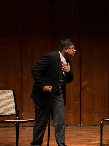 An actor delivers a dramatic monologue, using posture and expression to build his character.