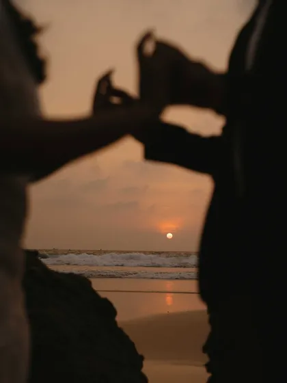A silhouette against the setting sun. I framed this shot to capture the intimacy of the couple holding hands, with the beautiful Goan sunset creating a perfect, romantic backdrop.