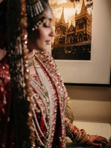 An artistic, soft-focus shot of the bride. This portrait emphasizes the rich colors and textures of her Nikaah attire, creating a dreamy and romantic mood.