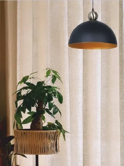 This statuesque pendant light features a black dome shade with a golden interior, casting a warm and inviting glow. The antique brass accent adds a touch of vintage charm to this modern fixture.