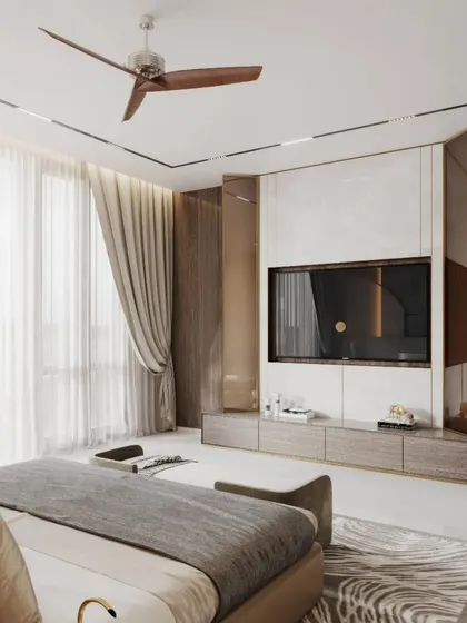 In this bedroom, we designed a full-wall media unit using white marble and wood veneer panels, framed by metal screens. The result is a clean, integrated look that combines storage and display with high-end finishes.