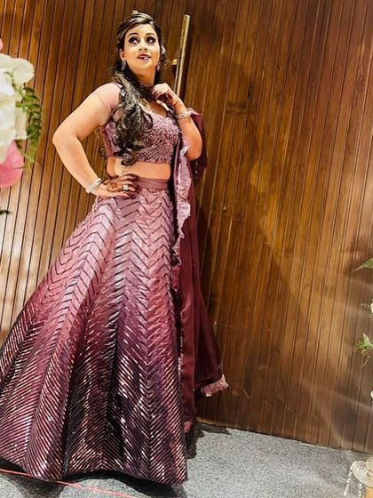 This full-length shot shows the modern chevron pattern of the sequins on the lehenga skirt. It's a contemporary design that is both elegant and eye-catching.