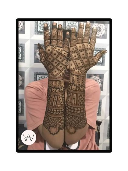 A full-arm back-hand design for Karwachauth, featuring a dense jaal pattern.