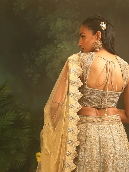 The back of the Jade Lehenga, showing the intricate blouse design and the beautiful drape of the scalloped dupatta. A modern take on a bridal classic.