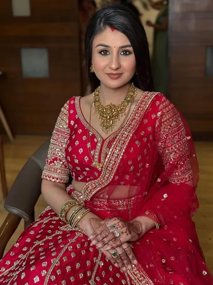 The bride looking directly at the camera, her confidence shining through. The soft glam reception makeup enhances her natural beauty perfectly.