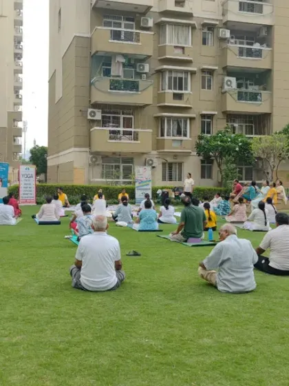 Another view of our large outdoor yoga class, showing people of all ages and backgrounds practicing together. Yoga is truly for everyone.