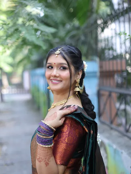 An over-the-shoulder view, showing the hairstyle and the beautiful details of her blouse.