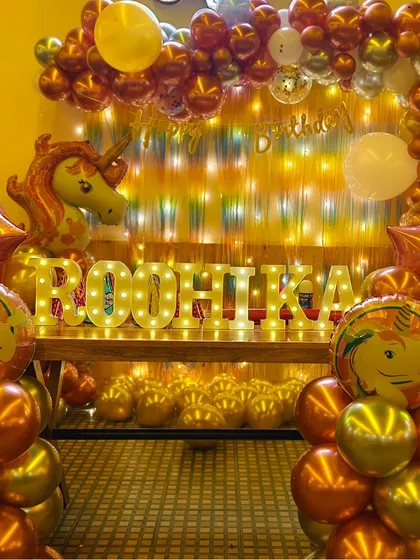 A grand and glittering unicorn-themed setup for Roohika's first birthday, using an abundance of chrome balloons for a luxurious feel.