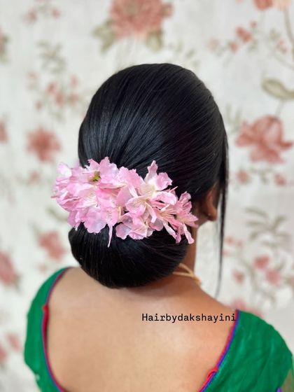 A final look at the simple and elegant sleek bun, a timeless choice.