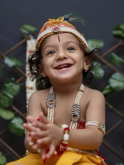 This little Krishna's joyful smile is infectious. Themed shoots are a wonderful way to celebrate your culture and create photos that are both personal and imaginative.