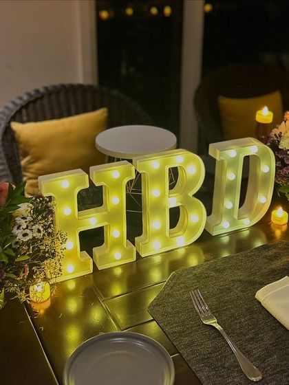 We can add personalized touches like these light-up 'HBD' letters to make your birthday dinner even more special.